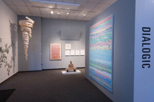 Contemporary art gallery interior featuring mixed media installations, colorful digital artwork, sculptural pieces, and minimalist wall displays under profes…