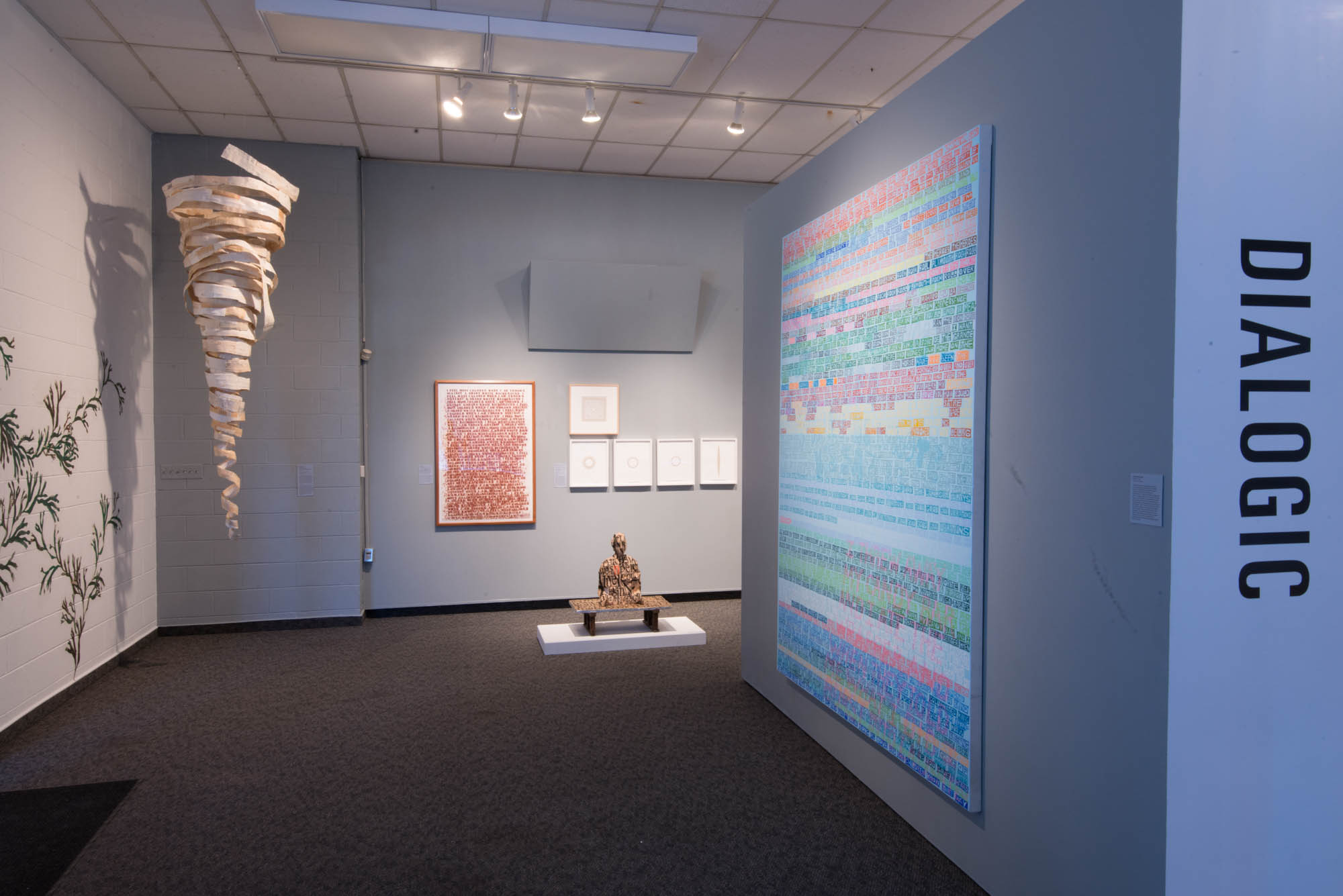 Contemporary art gallery interior featuring mixed media installations, colorful digital artwork, sculptural pieces, and minimalist wall displays under profes…
